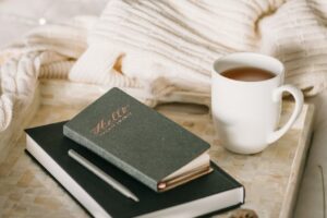 photo of cup beside books