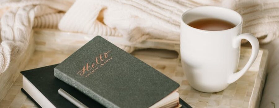 photo of cup beside books